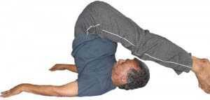 Man doing plow-pose